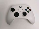 a close up of a white controller on a table
