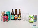 several different types of beer are lined up on a table