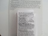 a small piece of paper on a table next to a pair of scissors