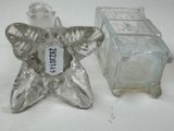 a small glass candle holder next to a small glass candle holder
