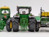 a toy tractor and a toy tractor on a white surface
