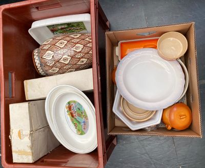 a box full of plates and bowls sitting on the floor