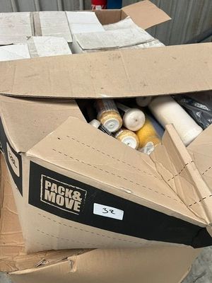 a cardboard box full of supplies sitting on the ground