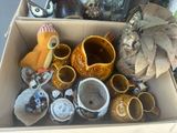 a cardboard box filled with many different types of vases