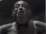 black and white photograph of a man with a bow tie in the water
