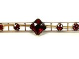 an image of a close up of a hair pin with red stones