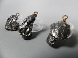 two pieces of metal are sitting on top of a clear plate