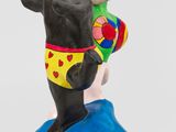 a figurine of a bear and a dog on a surfboard