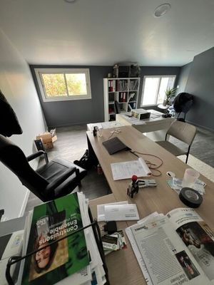 a desk with a chair and a book on it