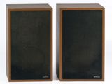 pair of speakers on a white surface with a white background
