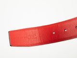 red leather belt on a white background with a silver buckle