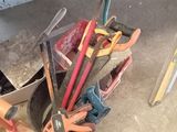 a pile of tools sitting on the floor next to a table