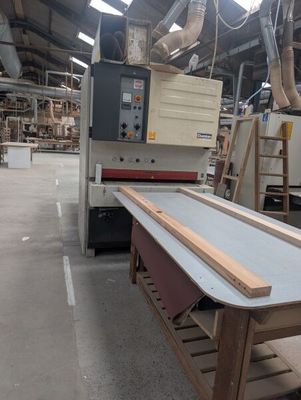 a picture of a table in a factory with a machine in the background