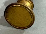 a gold clock with roman numerals on the face
