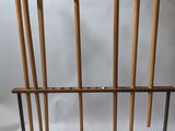 a rack with four wooden baseball bats and a bat holder