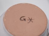 a close up of a jar of makeup with a smiley face drawn on it