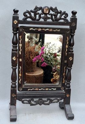 a mirror that is sitting on top of a stand