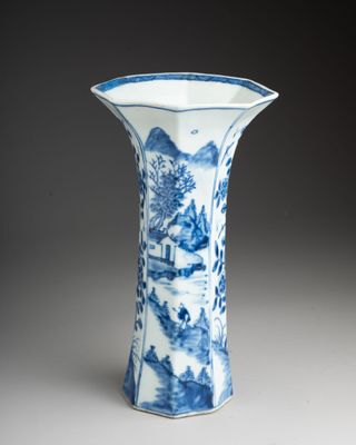 blue and white porcelain vase with a landscape scene on it
