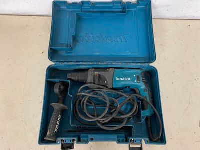a blue box with a cord and a drill in it