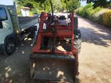 a tractor that is parked on the side of the road