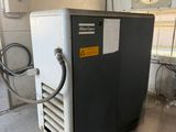 a small air conditioner in a garage with a fan