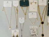 many different types of necklaces on display on the wall