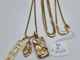 three gold necklaces with charms and tags on them