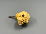 an image of a yellow dog head on a stick on a table