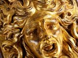 an image of a gold plaque with a woman ' s face on it