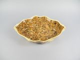 a close up of a bowl of dried herbs on a white surface