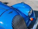 a close up of the front of a blue sports car