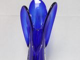 a blue glass vase with a blue angel on it