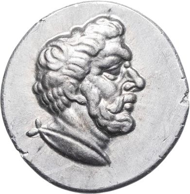 a close up of a coin with a man ' s face on it