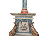 a blue and white table with a vase on top of it