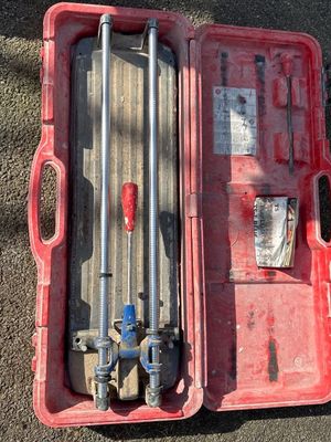 someone is standing next to a red tool box with tools in it