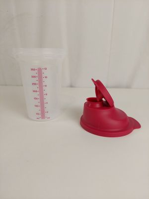 a plastic measuring cup and a plastic measuring cup on a table