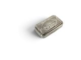 an old silver cigarette case sitting on top of a white surface