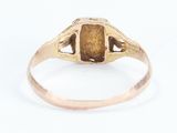 a close up of a gold ring with a brown stone