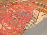 an image of a close up of a colorful rug on a white surface