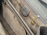 a close up of a purse on a white surface