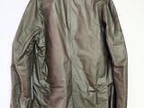the back of a jacket hanging on a hanger on a wall