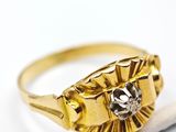 an image of a gold ring with a diamond on top of a cigarette