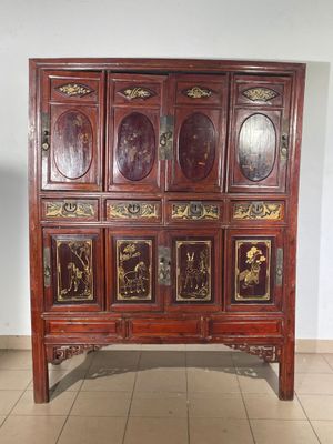 a wooden cabinet with many doors on it in a room