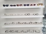 many pairs of glasses on the shelves in the store