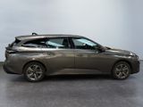the grey car is parked on the concrete floor in the room