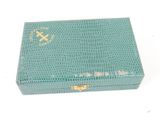 turquoise colored box with a gold cross on the lid