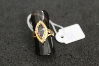 a close up of a ring on a black surface with a price tag