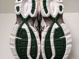 pair of green and white shoes sitting on top of a white table
