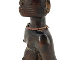 wooden figurine of a man with a hat on his head