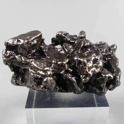 a metal sculpture of a bunch of rocks on a stand